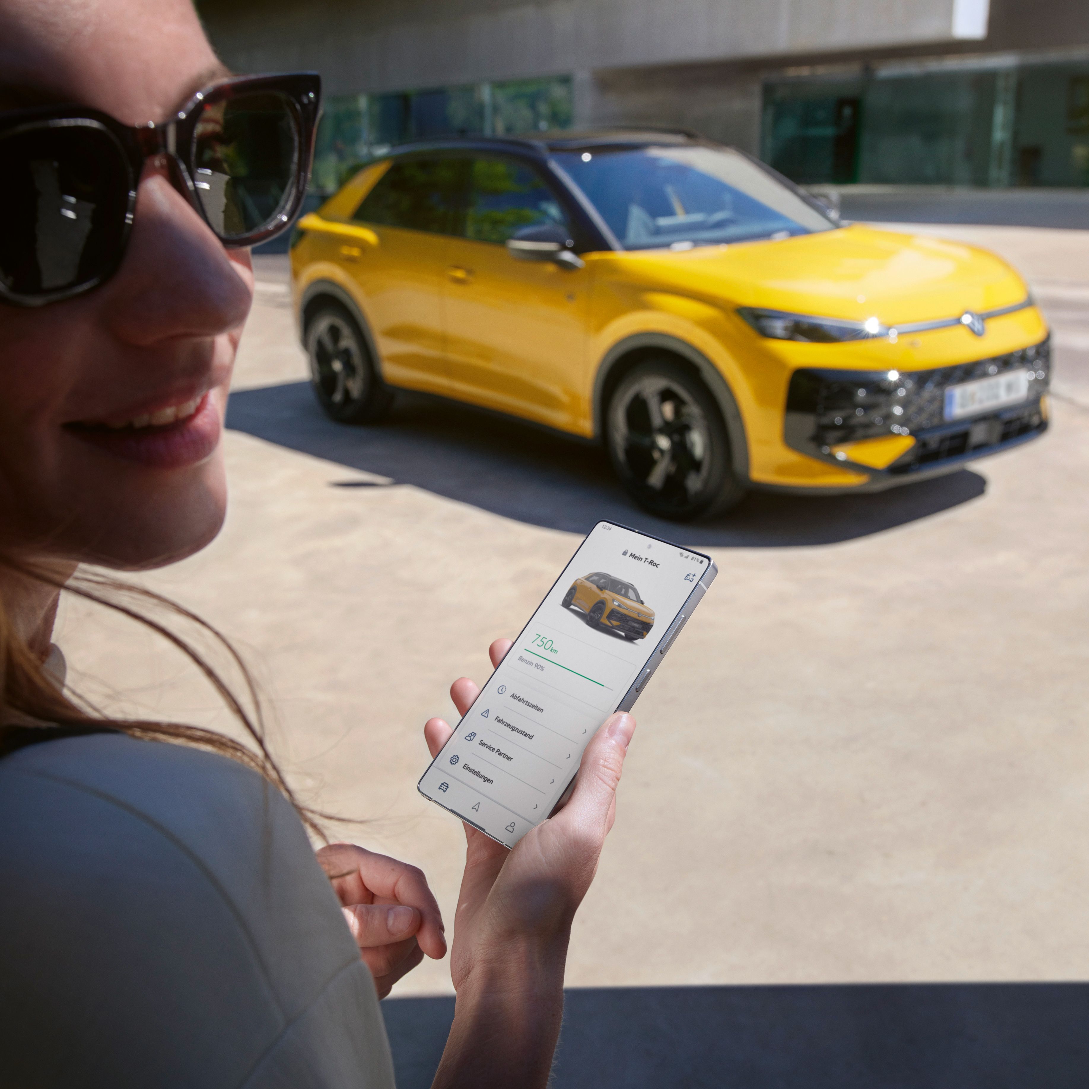 Egy nő kezében tartott telefonján a VW alkalmazás látszik